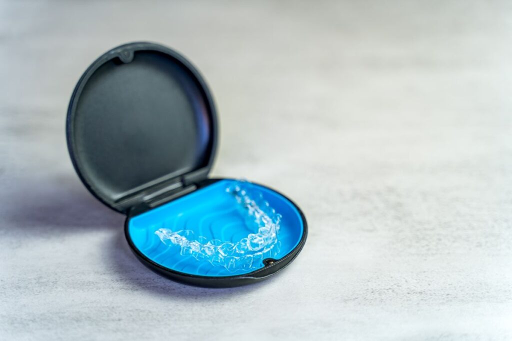 An Invisalign aligner in a storage case.